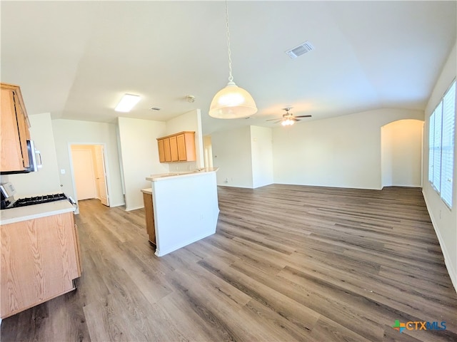 kitchen with light brown cabinets, white range, hardwood / wood-style flooring, ceiling fan, and decorative light fixtures