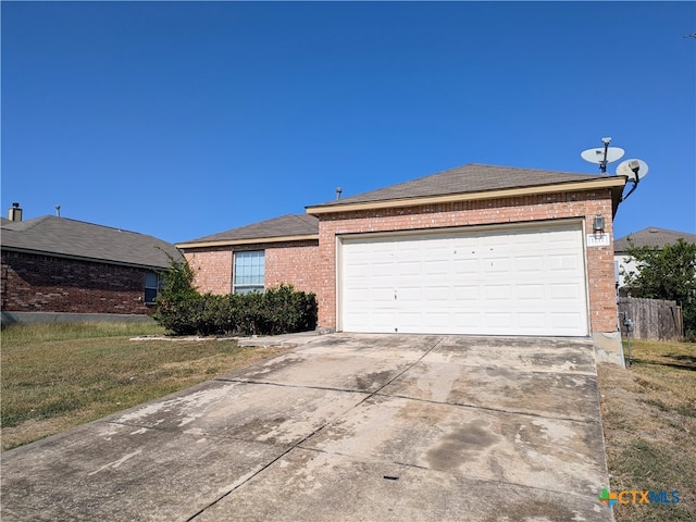 ranch-style home with a garage and a front yard