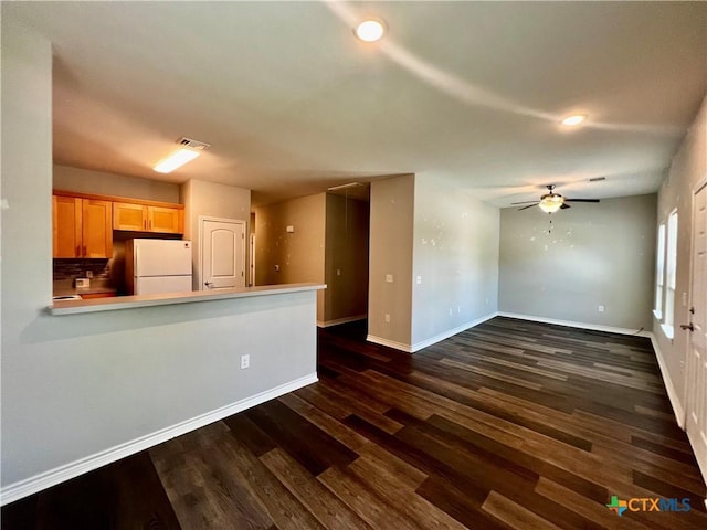 313 Rorem Ave, Palacios, TX 77465 - unfurnished living room with dark wood finished floors, recessed lighting, ceiling fan, baseboards, and visible vents