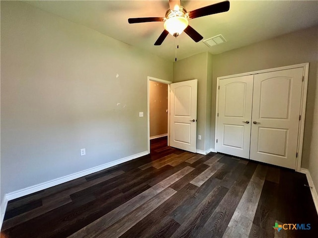 313 Rorem Ave, Palacios, TX 77465 - unfurnished bedroom featuring visible vents, ceiling fan, a closet, baseboards, and dark wood-type flooring