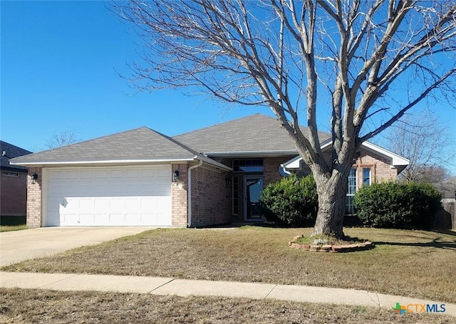 single story home with a garage and a front lawn