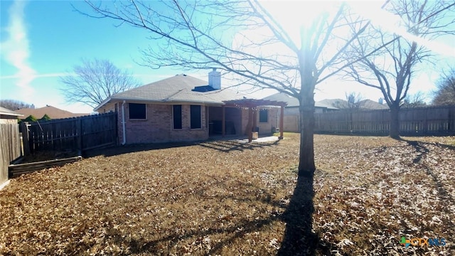 rear view of property featuring a pergola