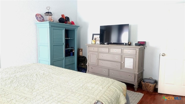 bedroom featuring dark hardwood / wood-style flooring