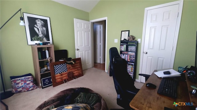 carpeted office featuring lofted ceiling