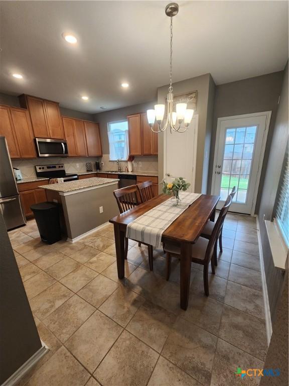 1306 Daniel Dr, Belton, TX 76513 - dining space with a chandelier, recessed lighting, light tile patterned flooring, and baseboards