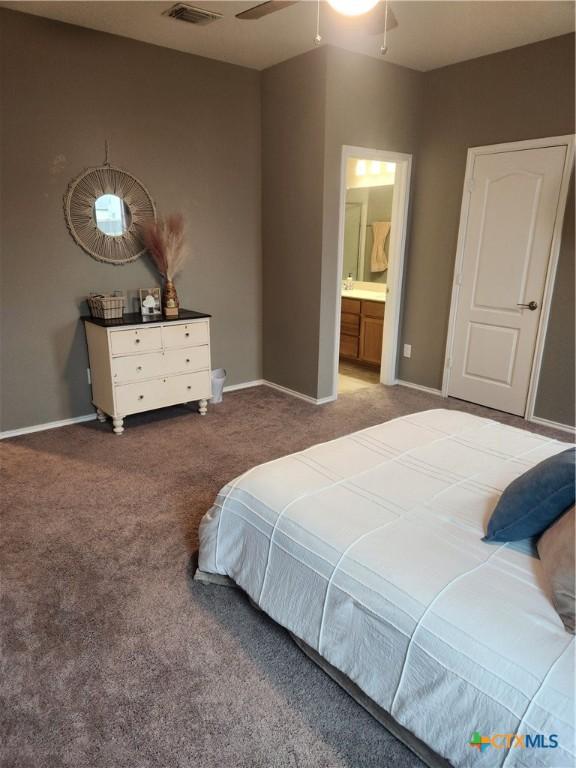 1306 Daniel Dr, Belton, TX 76513 - carpeted bedroom featuring baseboards, ensuite bathroom, and a ceiling fan