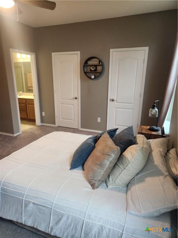 1306 Daniel Dr, Belton, TX 76513 - bedroom with light carpet, ensuite bath, baseboards, and ceiling fan
