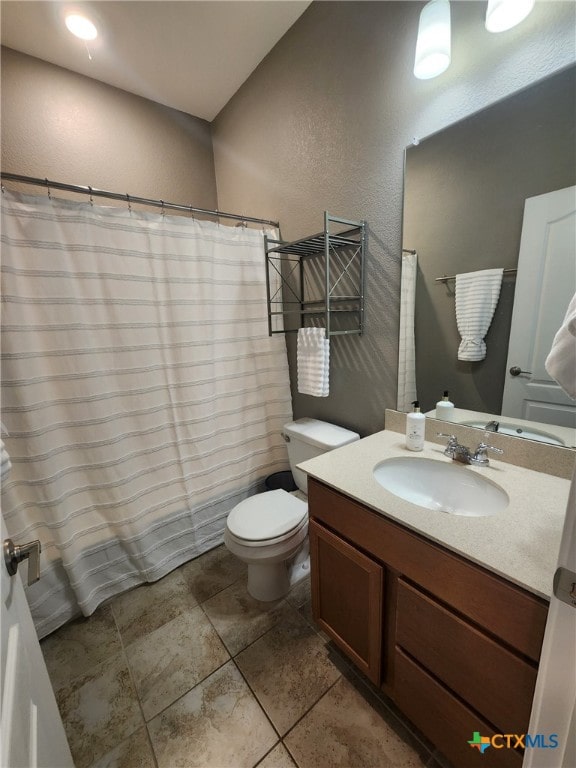 1306 Daniel Dr, Belton, TX 76513 - bathroom with vanity, toilet, a textured wall, and a shower with shower curtain