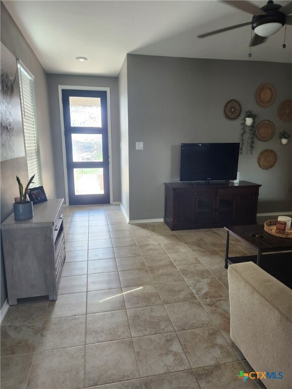 1306 Daniel Dr, Belton, TX 76513 - living area featuring light tile patterned flooring, ceiling fan, and baseboards