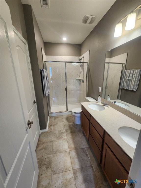 1306 Daniel Dr, Belton, TX 76513 - bathroom featuring a stall shower, toilet, and double vanity