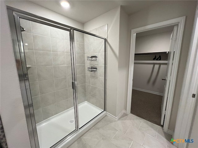 bathroom with walk in shower and tile patterned floors