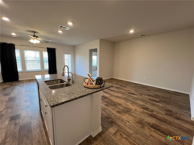 kitchen featuring sink, an island with sink, dark hardwood / wood-style floors, ceiling fan, and white cabinetry