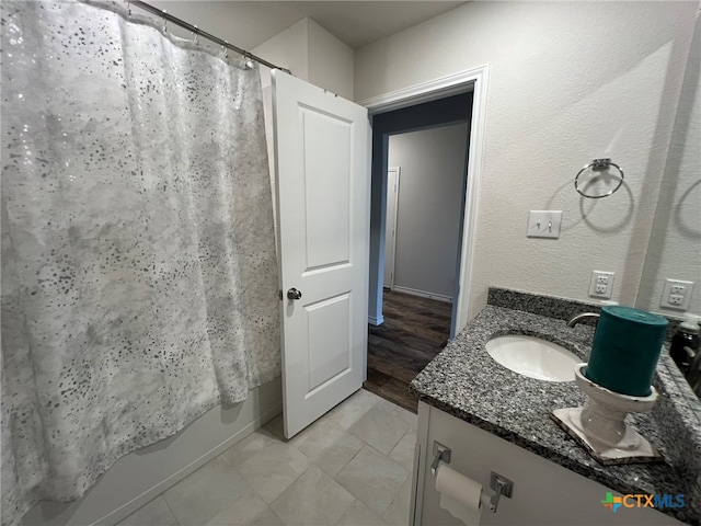 bathroom featuring vanity, hardwood / wood-style flooring, and shower / tub combo