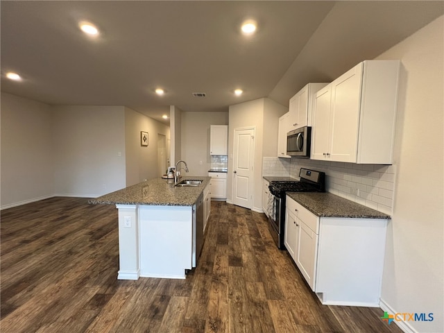 kitchen with dark hardwood / wood-style flooring, sink, a kitchen island with sink, white cabinetry, and appliances with stainless steel finishes