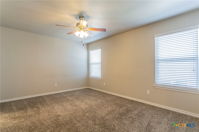 empty room with ceiling fan and carpet floors