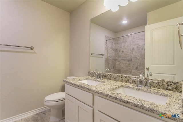 bathroom featuring toilet, vanity, and tile patterned floors