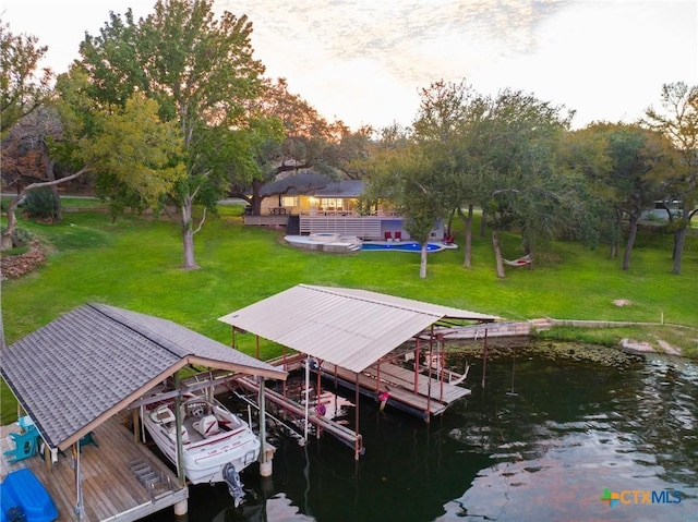 dock area with a yard, a water view, boat lift, and a gazebo