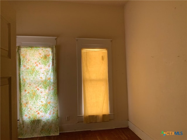 empty room featuring dark hardwood / wood-style flooring