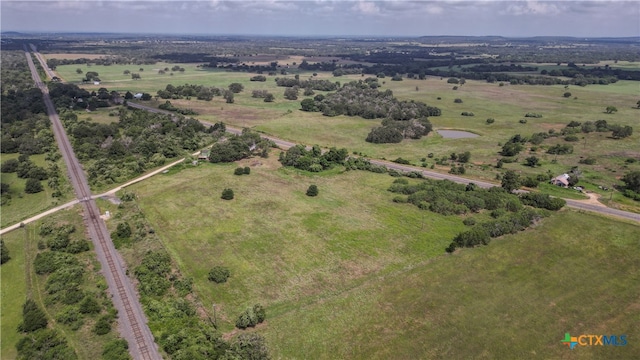 birds eye view of property with a rural view