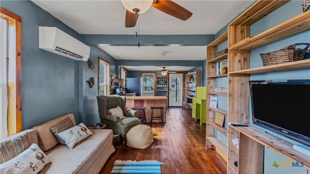 living room with dark hardwood / wood-style flooring, a wall unit AC, and ceiling fan