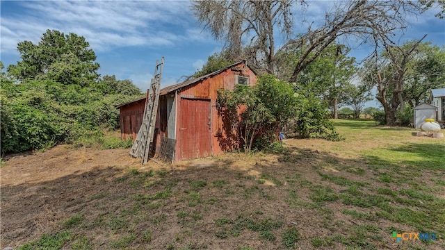 view of outdoor structure featuring a lawn