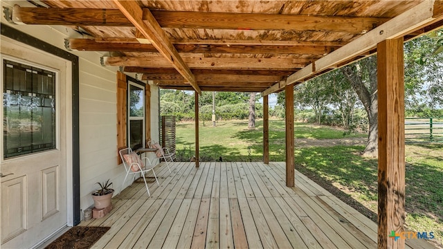 unfurnished sunroom featuring beamed ceiling and wood ceiling