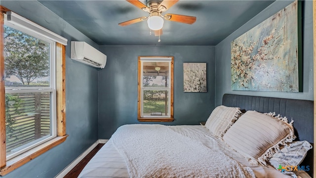 bedroom with ceiling fan, wood-type flooring, and a wall mounted AC