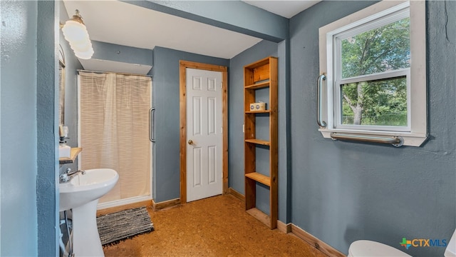 bathroom with walk in shower and sink