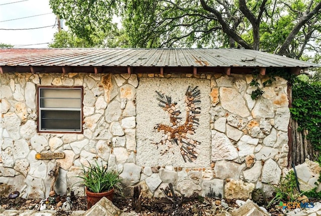 1218 Oakwood Loop, San Marcos, TX 78666 - view of home's exterior featuring stone siding and a metal roof