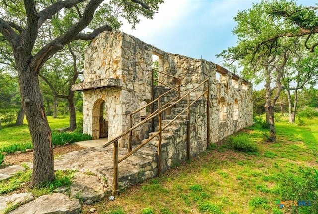1218 Oakwood Loop, San Marcos, TX 78666 - view of side of property with stone siding and stairway