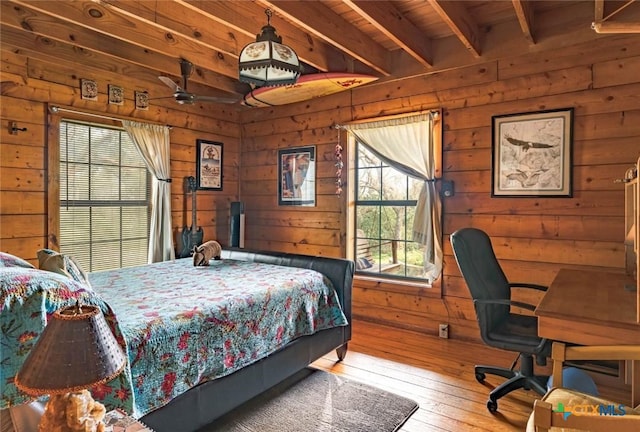 1218 Oakwood Loop, San Marcos, TX 78666 - bedroom featuring wooden walls, wood-type flooring, and an office area