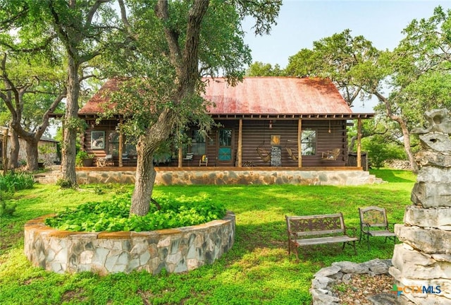 1218 Oakwood Loop, San Marcos, TX 78666 - rear view of property featuring log siding, a yard, and a metal roof