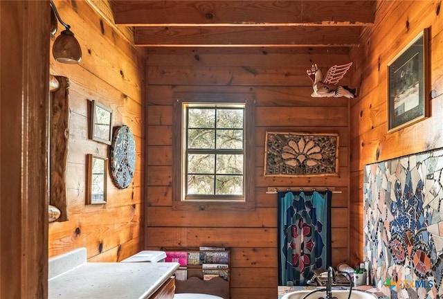 1218 Oakwood Loop, San Marcos, TX 78666 - doorway to outside featuring wood walls and beam ceiling
