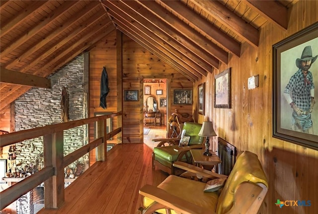 1218 Oakwood Loop, San Marcos, TX 78666 - living area featuring wooden walls, wood ceiling, an upstairs landing, and wood-type flooring