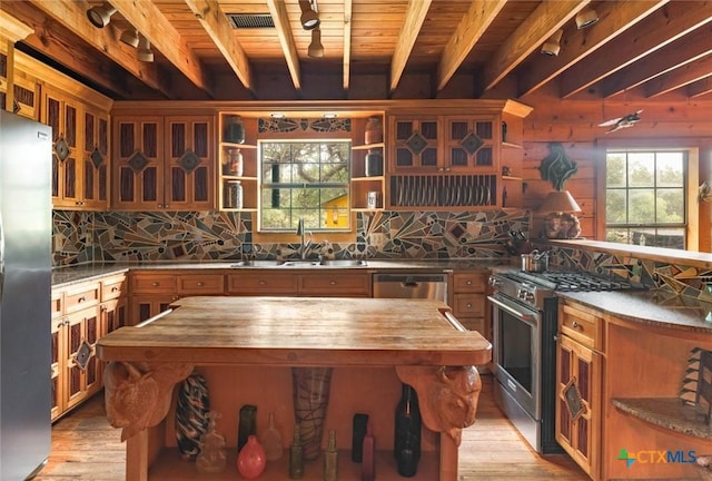 1218 Oakwood Loop, San Marcos, TX 78666 - kitchen featuring wooden counters, stainless steel appliances, open shelves, a wooden ceiling with exposed beams, and brown cabinetry