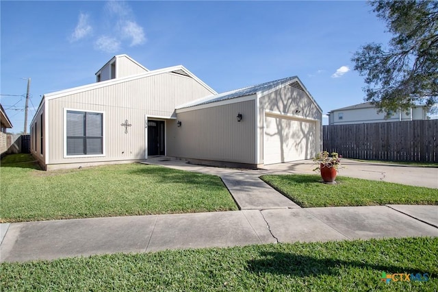 view of front of property with a garage and a front lawn