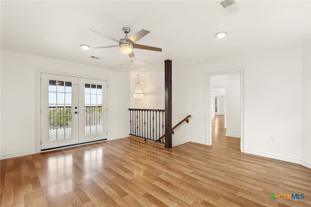 spare room with light hardwood / wood-style flooring, french doors, and ceiling fan