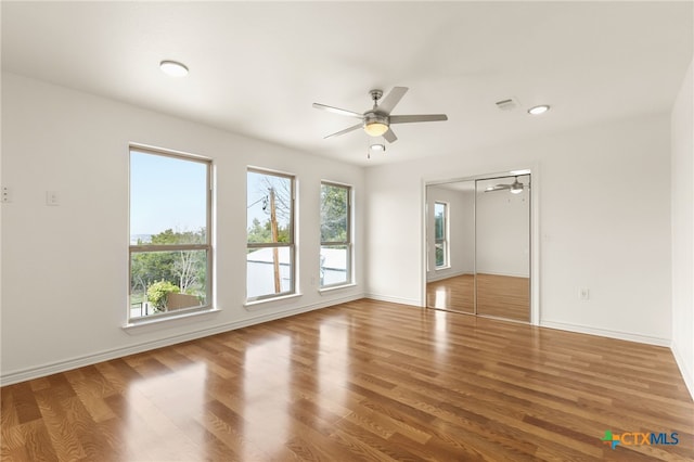 empty room featuring wood-type flooring and ceiling fan