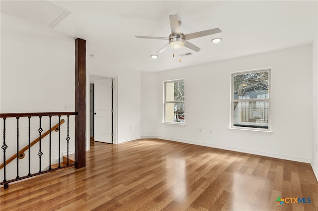 spare room featuring hardwood / wood-style floors and ceiling fan