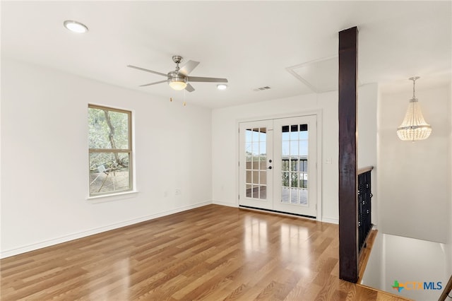 unfurnished room with hardwood / wood-style floors, ceiling fan, and french doors