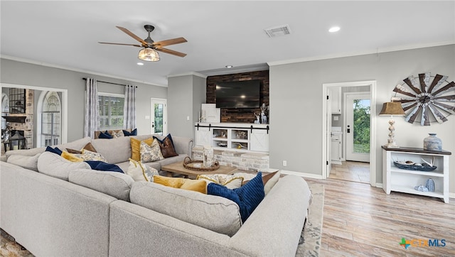 living room featuring visible vents, recessed lighting, and ornamental molding