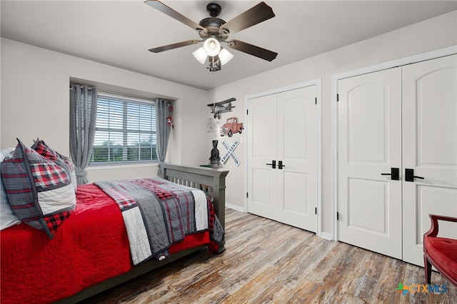 bedroom with a ceiling fan, wood finished floors, and baseboards