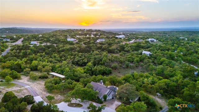 bird's eye view featuring a wooded view