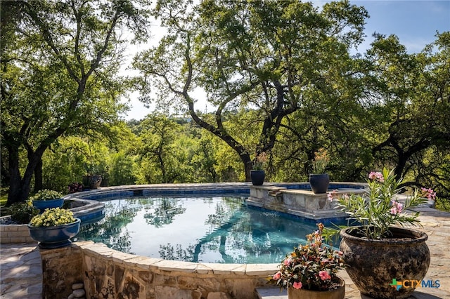 pool with an outdoor hot tub