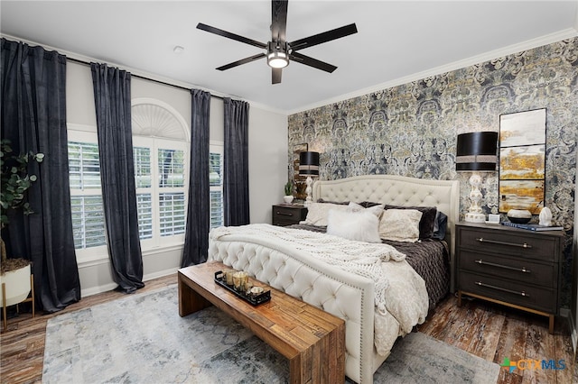 bedroom with wood finished floors, ceiling fan, and crown molding
