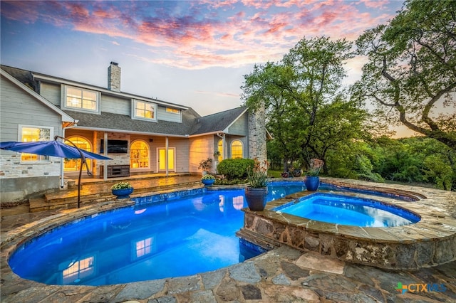 outdoor pool with an in ground hot tub