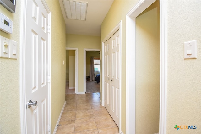 corridor with light tile patterned flooring