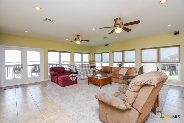 living room featuring light tile patterned floors and ceiling fan