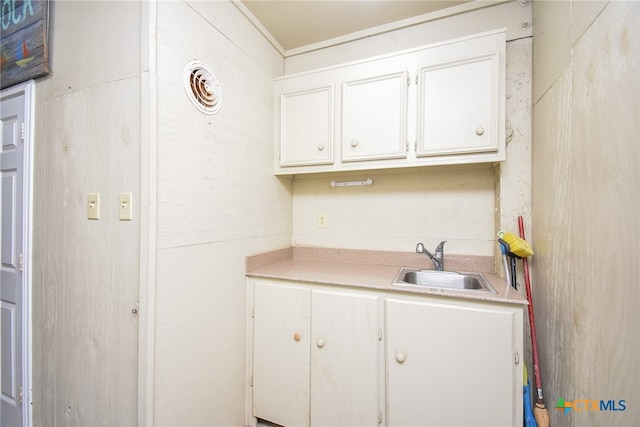 kitchen with white cabinetry and sink