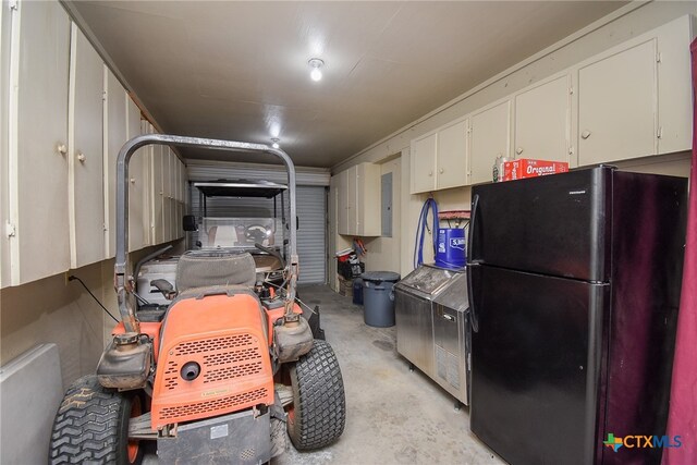 garage with black refrigerator and electric panel